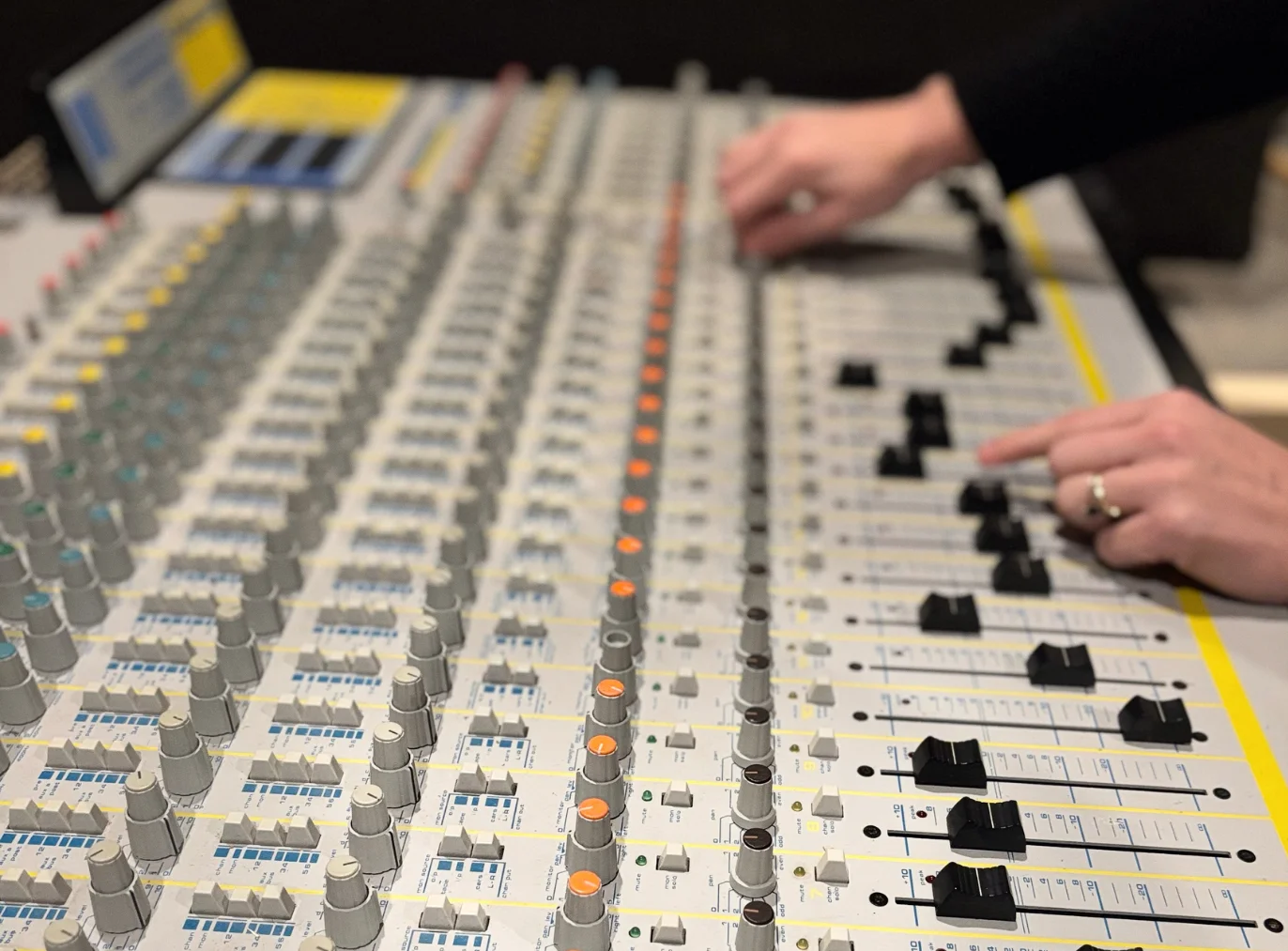 person sitting in front of soundboard